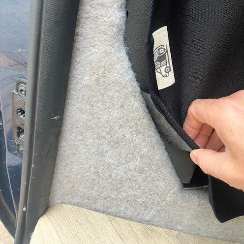 Hand fitting the KabinKurtain into the Ford Transit Custom side trim